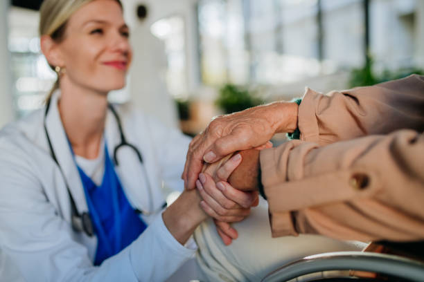 close up of young doctor holding hands of patient, consoling her.